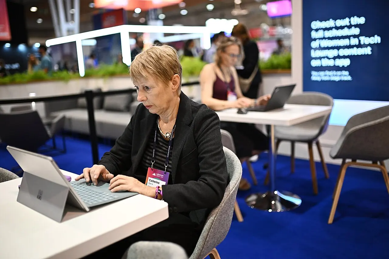 A woman working with a laptop in a technology lounge